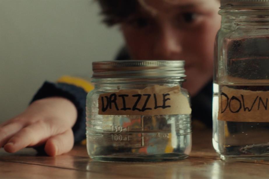 Boy looking at jars of water