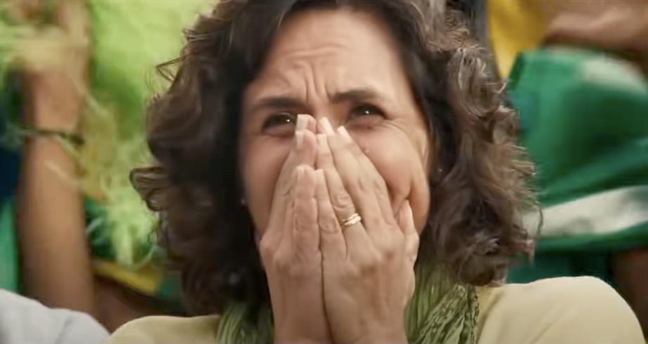 Woman in crowd with hands over her mouth